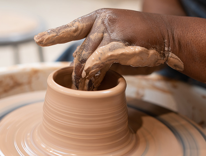 Student creating a pot